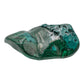 The same malachite specimen from a mirrored angle, showing concentric green rings across the lower two-thirds of the stone.