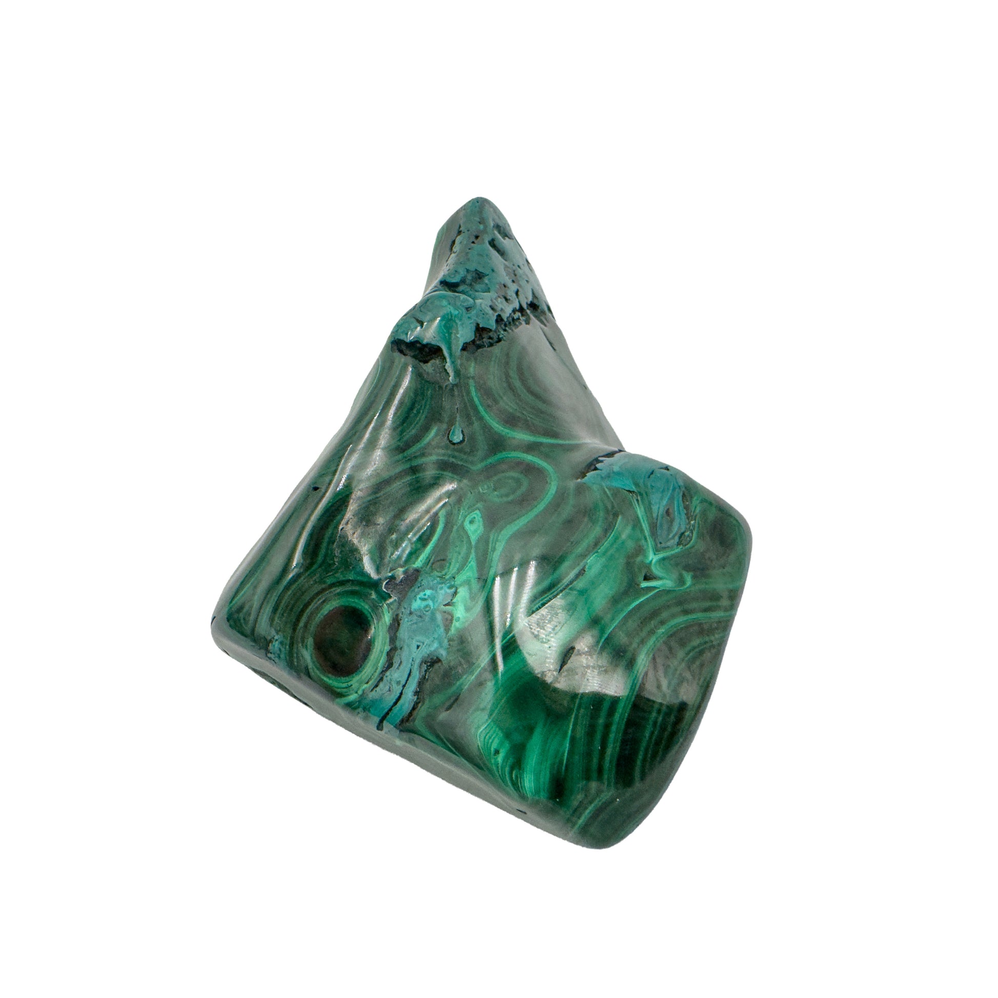 Malachite specimen photographed from below, its peaked silhouette rising above the banded base.