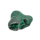 The same malachite specimen from a front angle, with green banding curving around several lobed peaks.