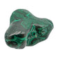 The same malachite specimen from a front angle, with green banding curving around several lobed peaks.