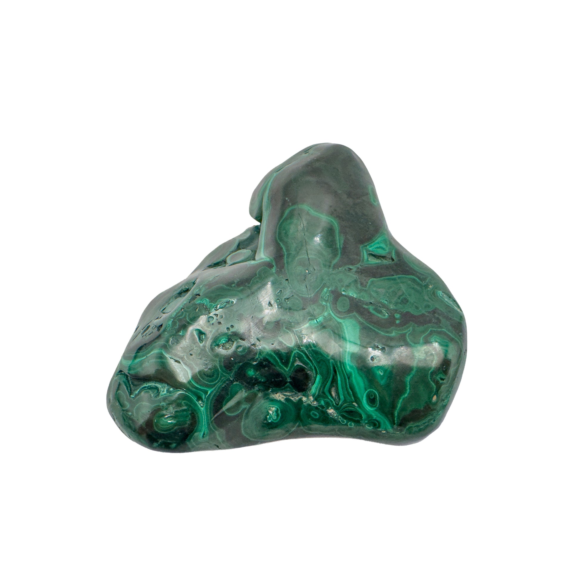 Dramatic angled view of the malachite specimen, with its tallest peak and a dark recessed pocket both visible.