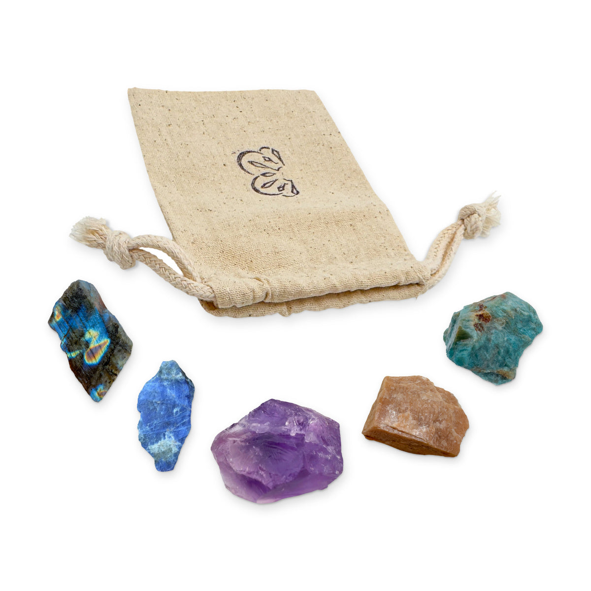 Moon & Intuition Crystal Kit: labradorite, sodalite, amethyst, peach moonstone and blue apatite, arranged with the reusable cotton bag they come in, on white