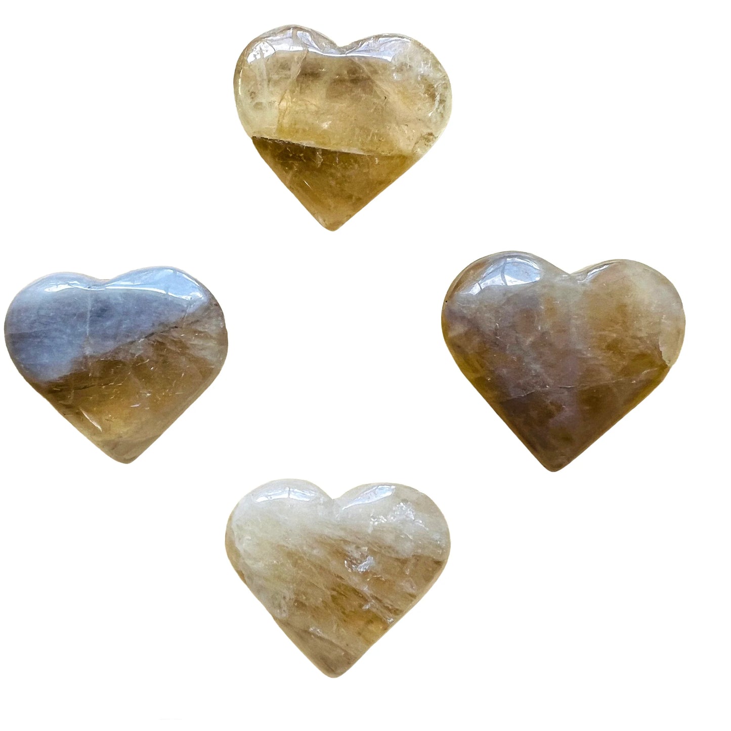 Held in hand, a Natural Citrine polished heart held against natural backdrop.