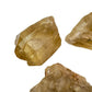 In-hand view of a Natural Citrine raw stone held against natural backdrop, from Democratic Republic of the Congo.