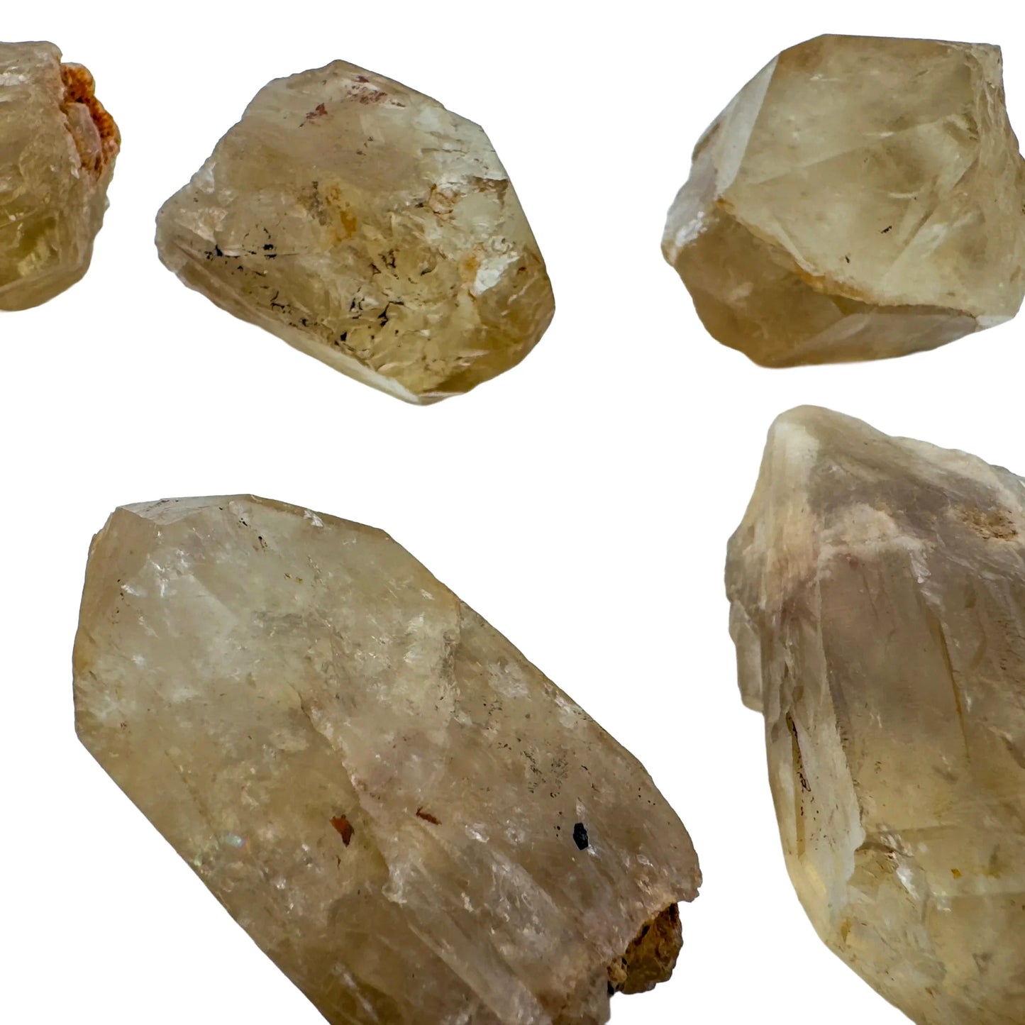 Set against a soft backdrop is a Natural Citrine stone, from Haut-Lomami, Democratic Republic of the Congo, shown at hand scale.
