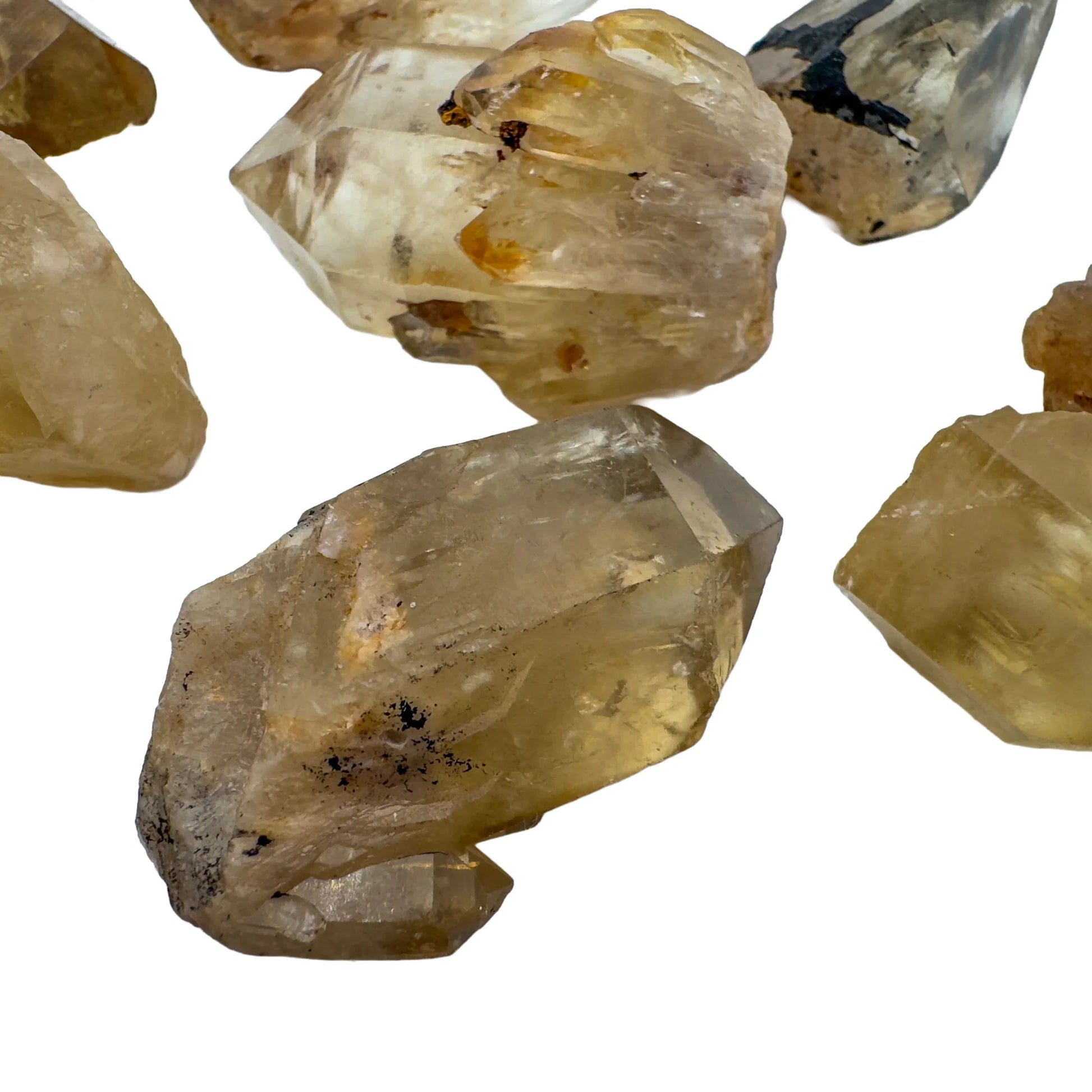Hand-held view of a Natural Citrine raw stone to support Abundance and Manifestation.