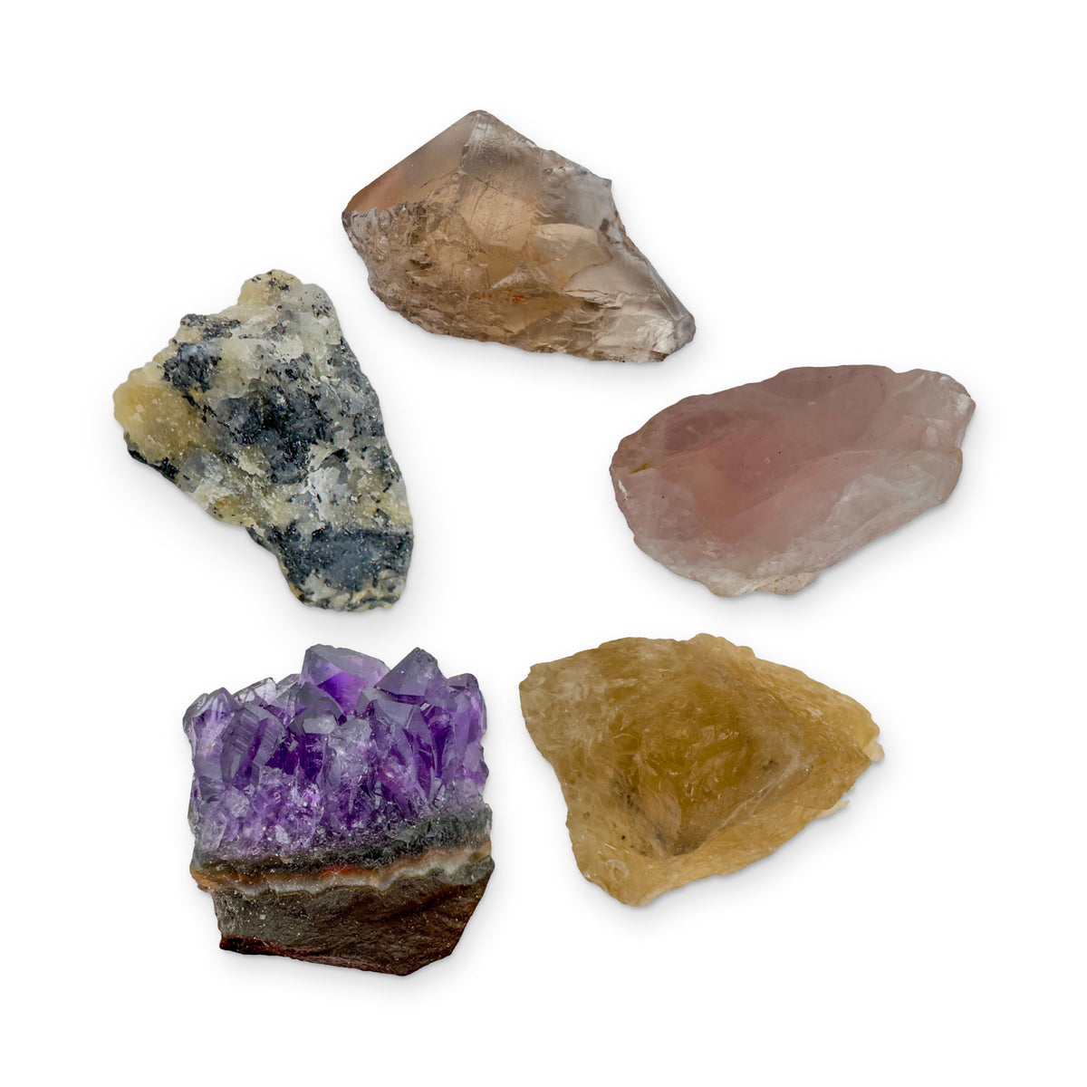 The New Home Kit: amethyst cluster, black tourmaline in quartz, smoky quartz, rose quartz and natural citrine, shown together on white