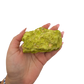 A hand holds nontronite no. 11 for scale, the 158 gram specimen spanning roughly 3.60 inches across the palm.