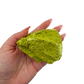 Nontronite no. 18 cupped in a hand, giving a sense of the 2.17 inch height and 218 gram weight.