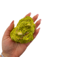 Nontronite specimen no. 25 held in an open hand, showing the true size of this 3.67 inch, 210 gram piece.