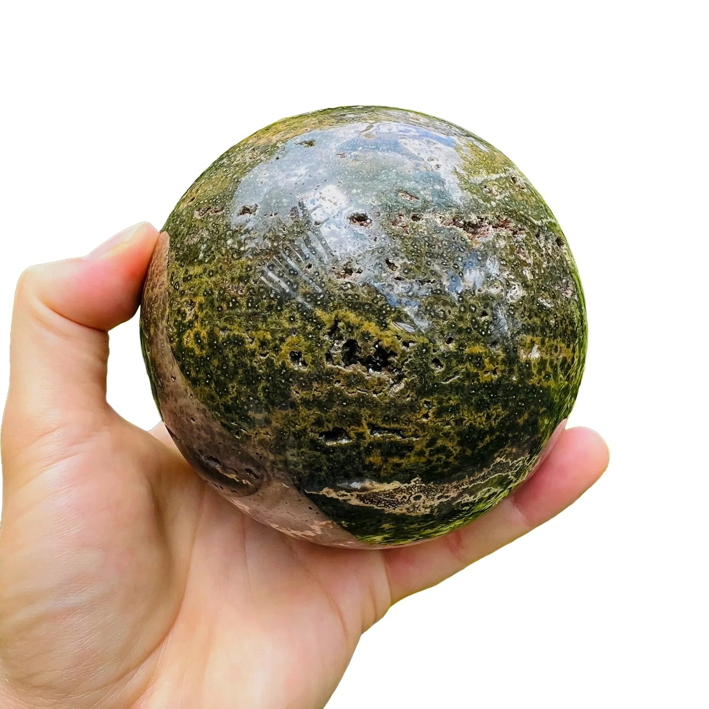 Hand-held view of one Ocean Jasper polished sphere for scale, from Madagascar.