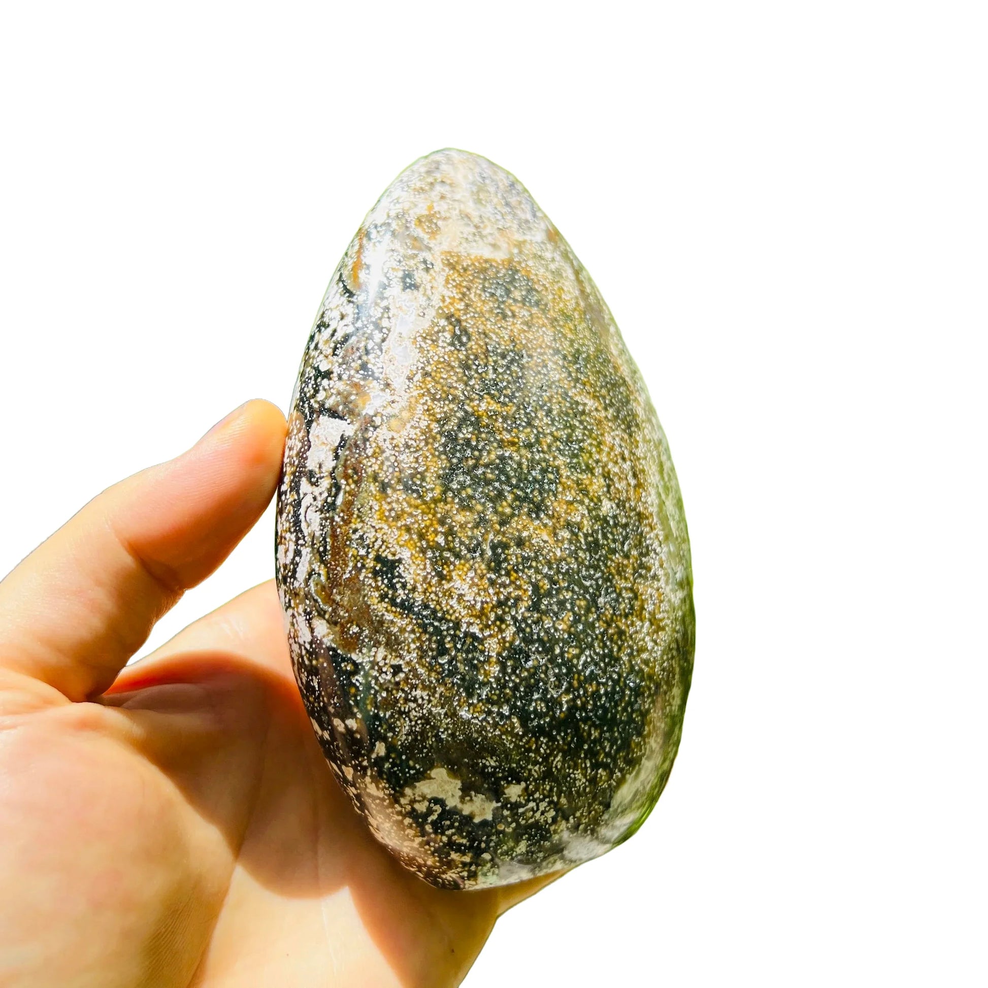 Held in palm of an Ocean Jasper stone, traditionally used for Emotional Healing, with natural details visible.