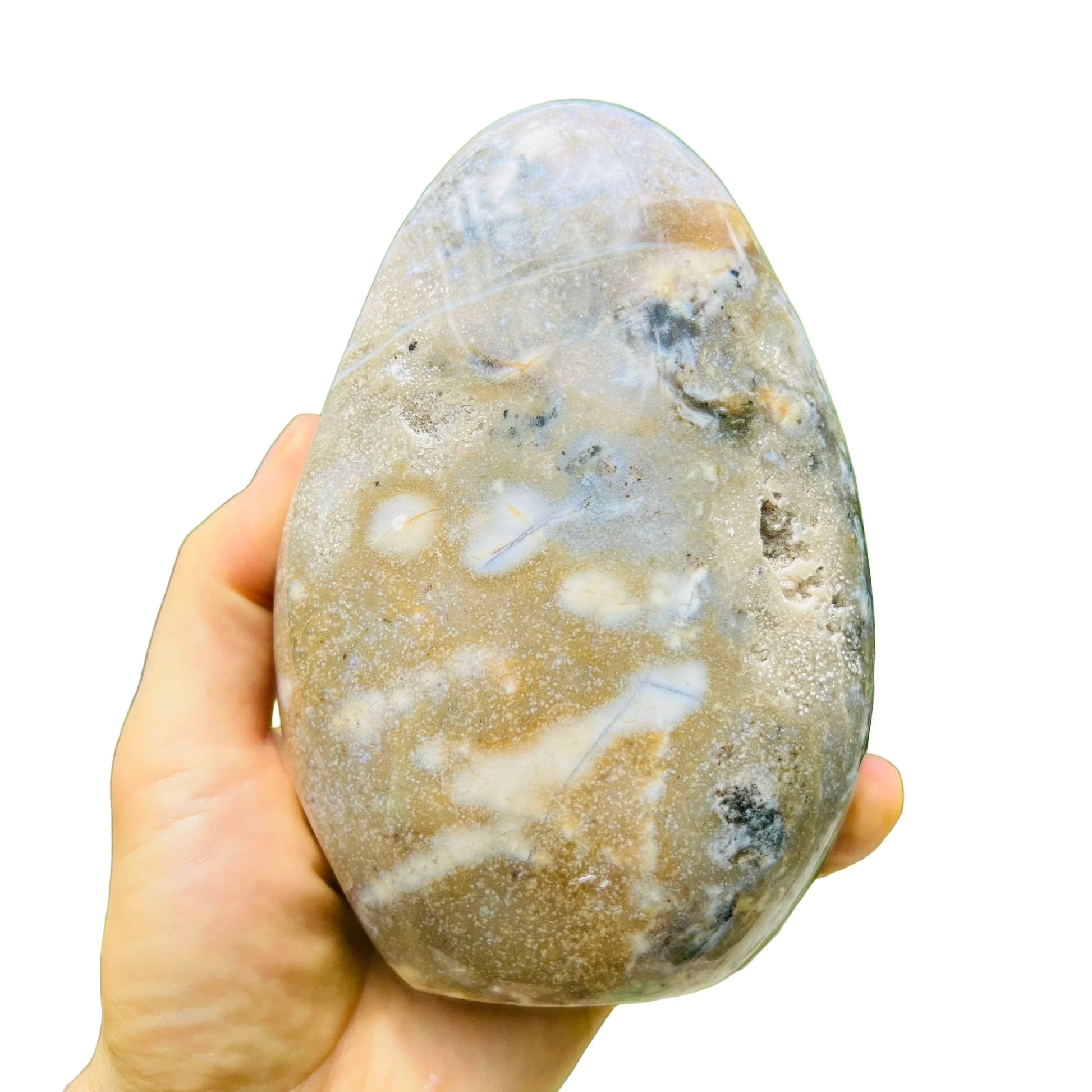 Held in hand, a Ocean Jasper freeform held against natural backdrop.
