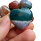 Detail shot of Grade AA Ocean Jasper heart under natural light