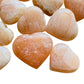 Side profile of Orange Calcite polished heart, from Madagascar.