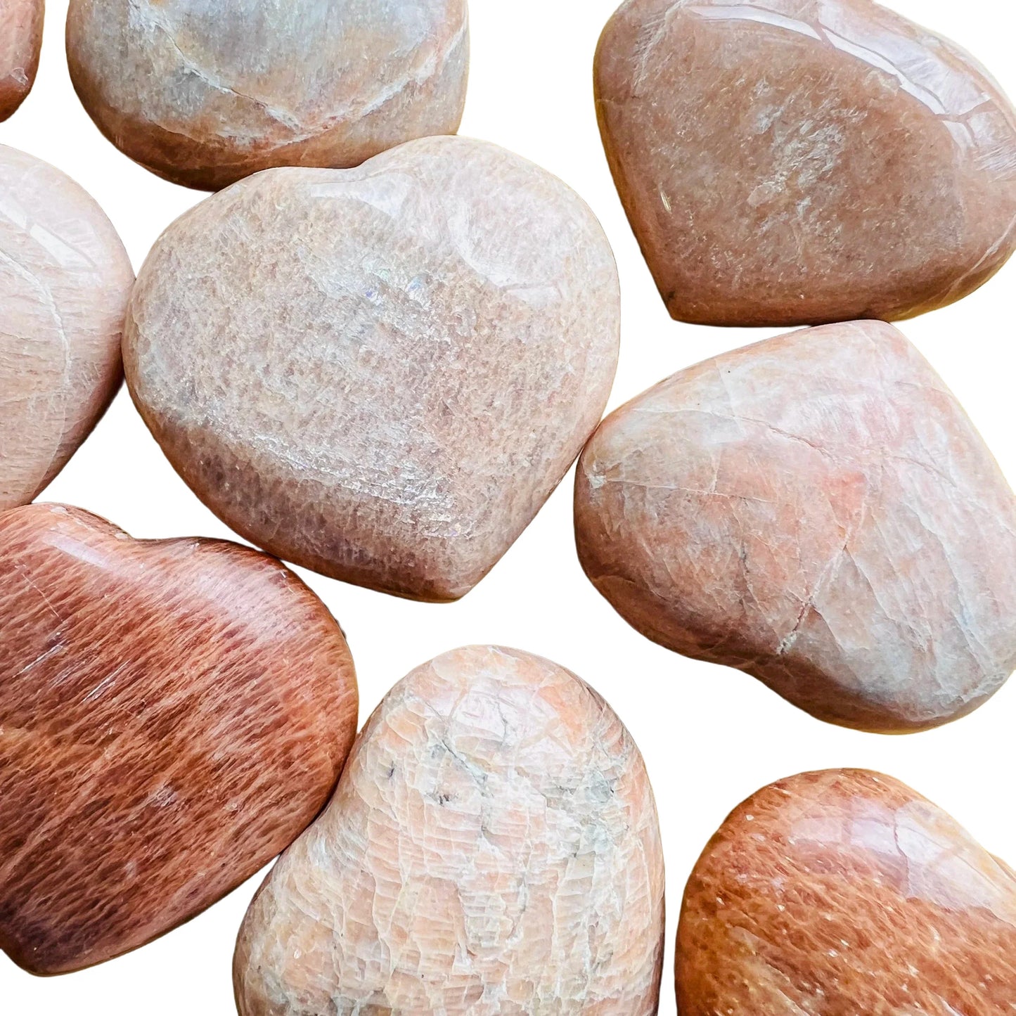 Natural light context of Peach Moonstone stone, from Alaotra-Mangoro, Madagascar, shown alongside the hand for scale.