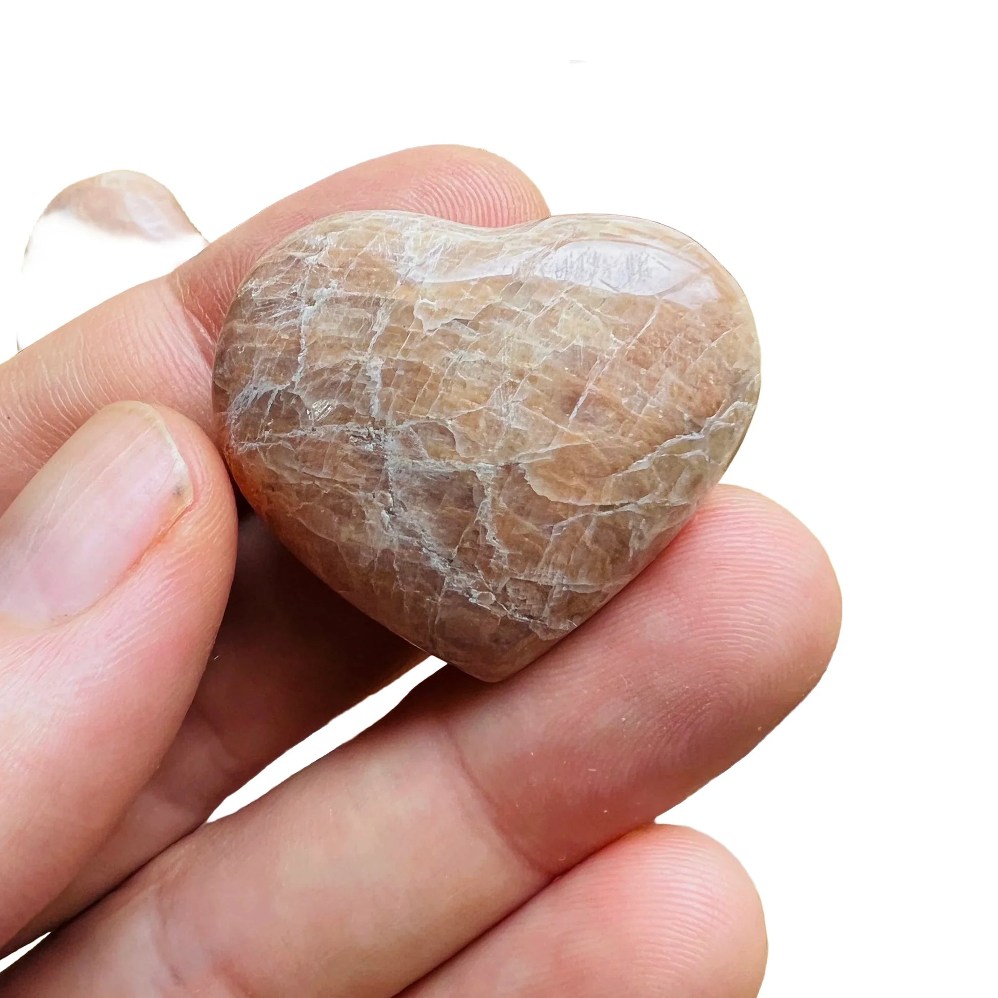 Detail shot of Grade AA Peach Moonstone heart under natural light