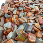 Petrified wood chips scattered on surface, ethically sourced Madagascar fossil wood