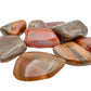 Pile of large Petrified Wood tumbled stones, AA grade from Madagascar