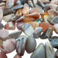 Pink agate polished chips in hand showing size reference, 0.25 to 0.50 inch pieces
