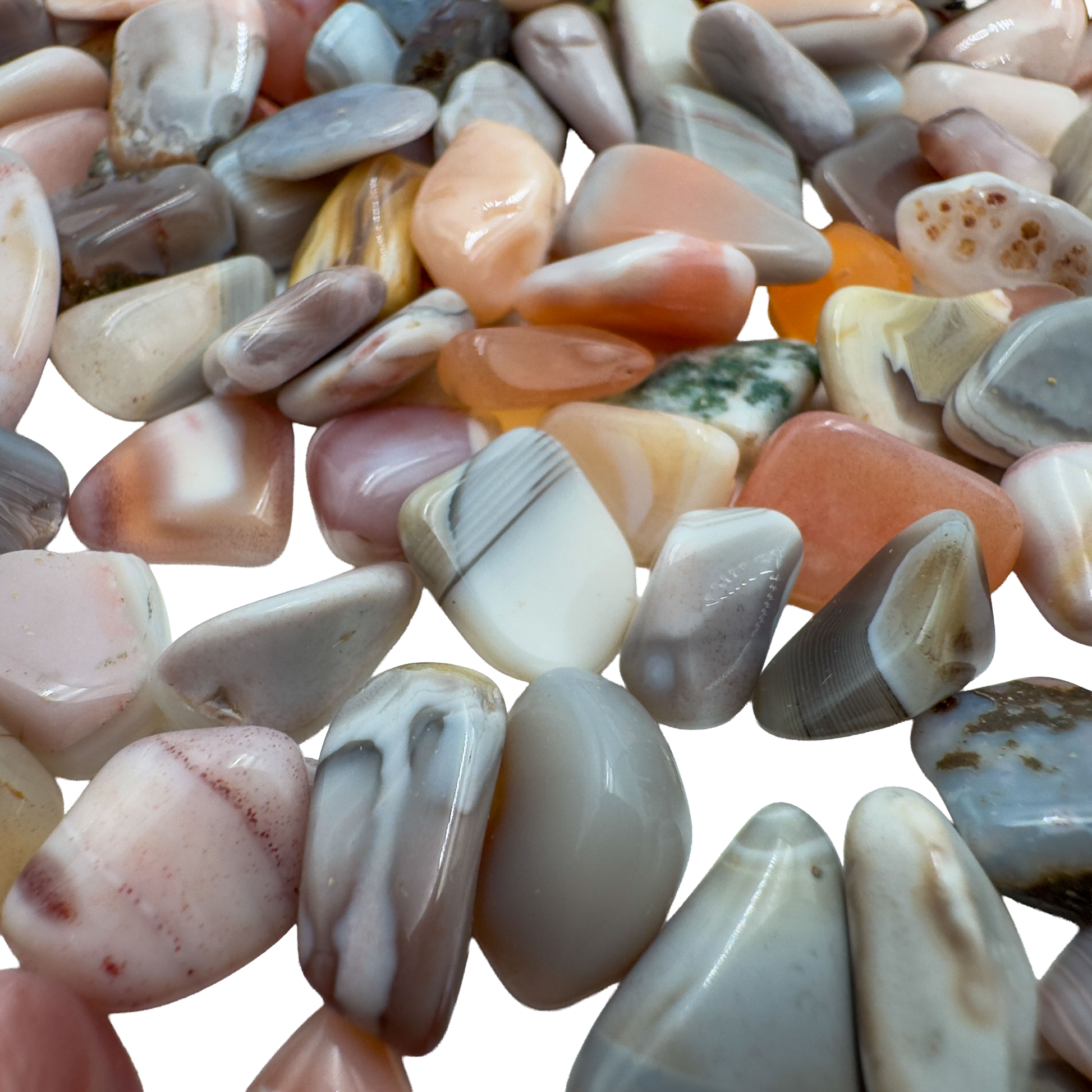 Pink agate polished chips in hand showing size reference, 0.25 to 0.50 inch pieces