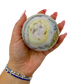 Pink Opal sphere no. 2 held in an open hand, showing the true scale of this 2.94 inch, 467 gram orb.