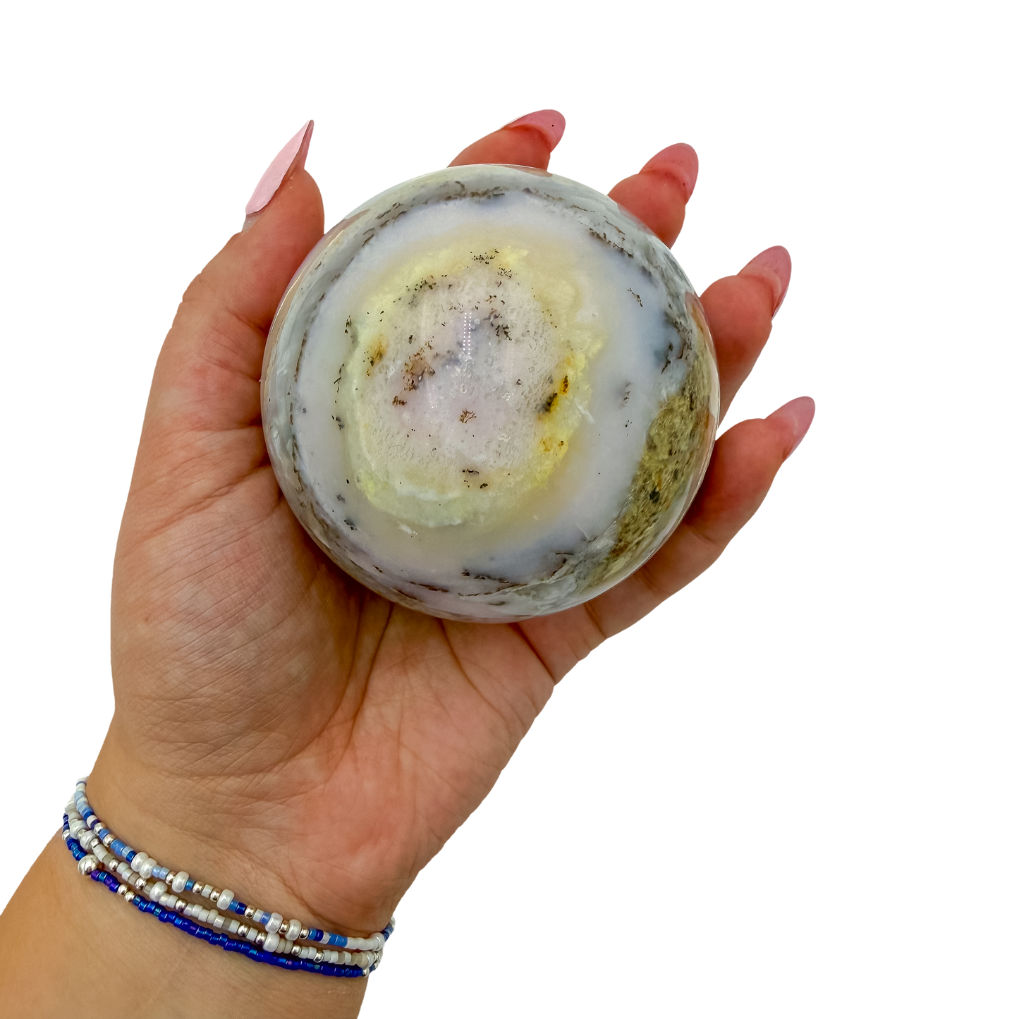Pink Opal sphere no. 2 held in an open hand, showing the true scale of this 2.94 inch, 467 gram orb.