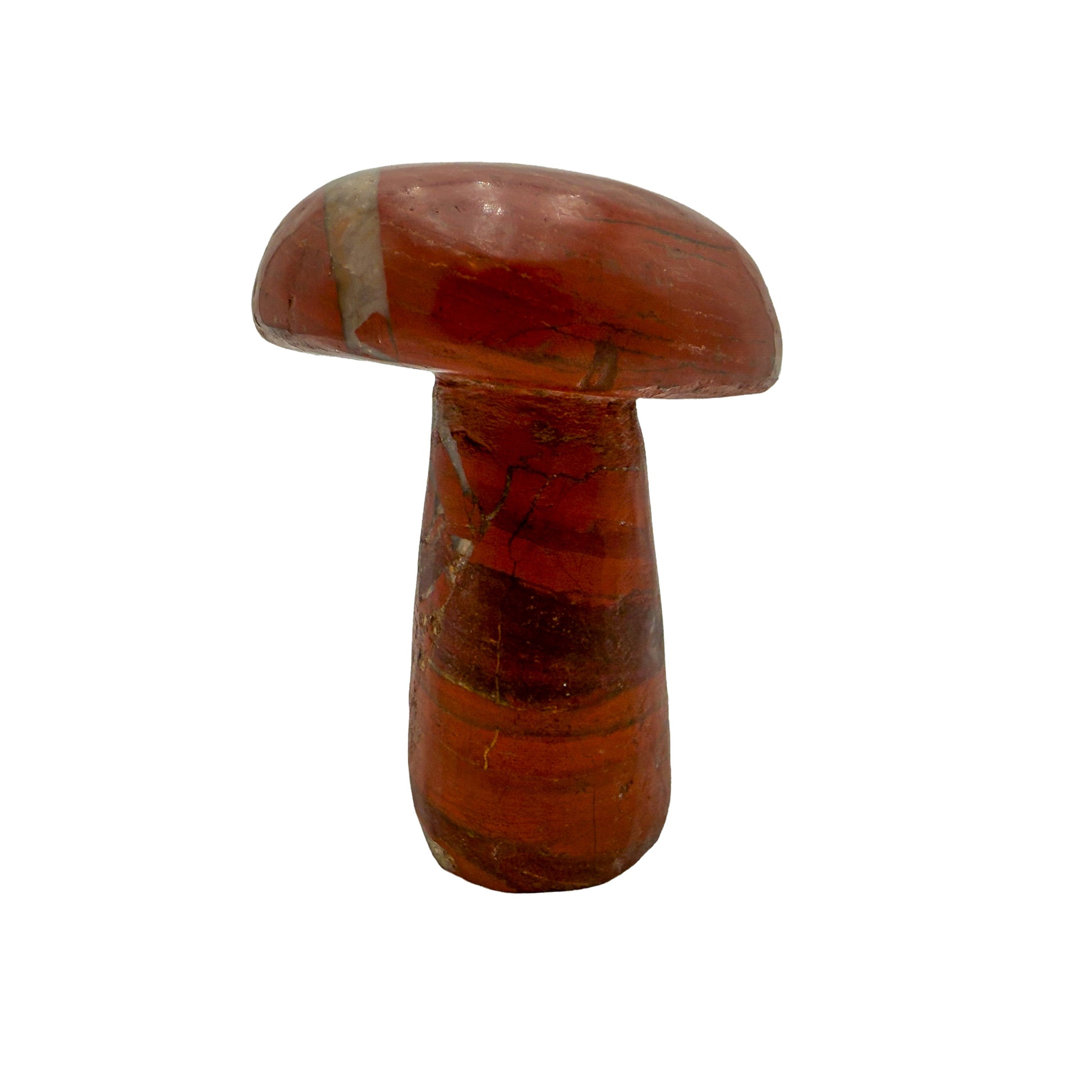 Angled view of a 1.70 pound red jasper mushroom carving, darker iron seams crossing the polished surface.