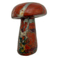 Top-down view of the red jasper mushroom cap, iron banding exposed across the polished dome.