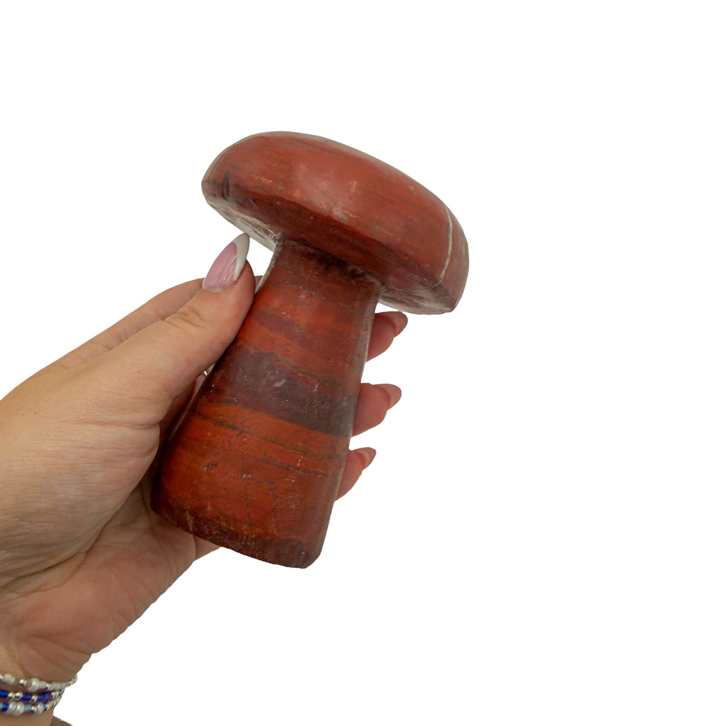 Red jasper mushroom no. 3 held in an open hand, showing the true scale of this 4.69 inch, 1.70 pound carving.