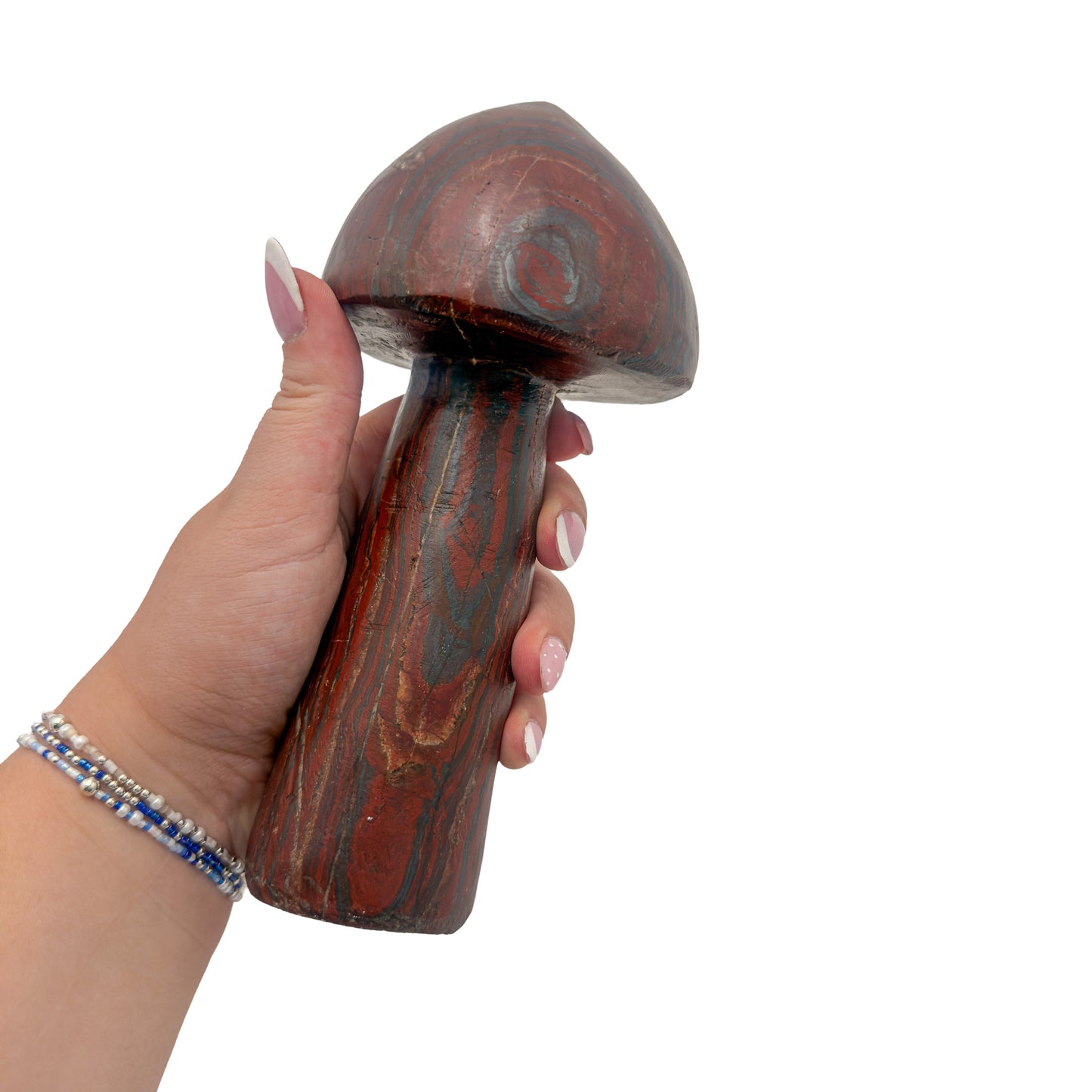 Tiger iron mushroom no. 4 held in an open hand, showing the true scale of this 7.31 inch, 2.76 pound carving.