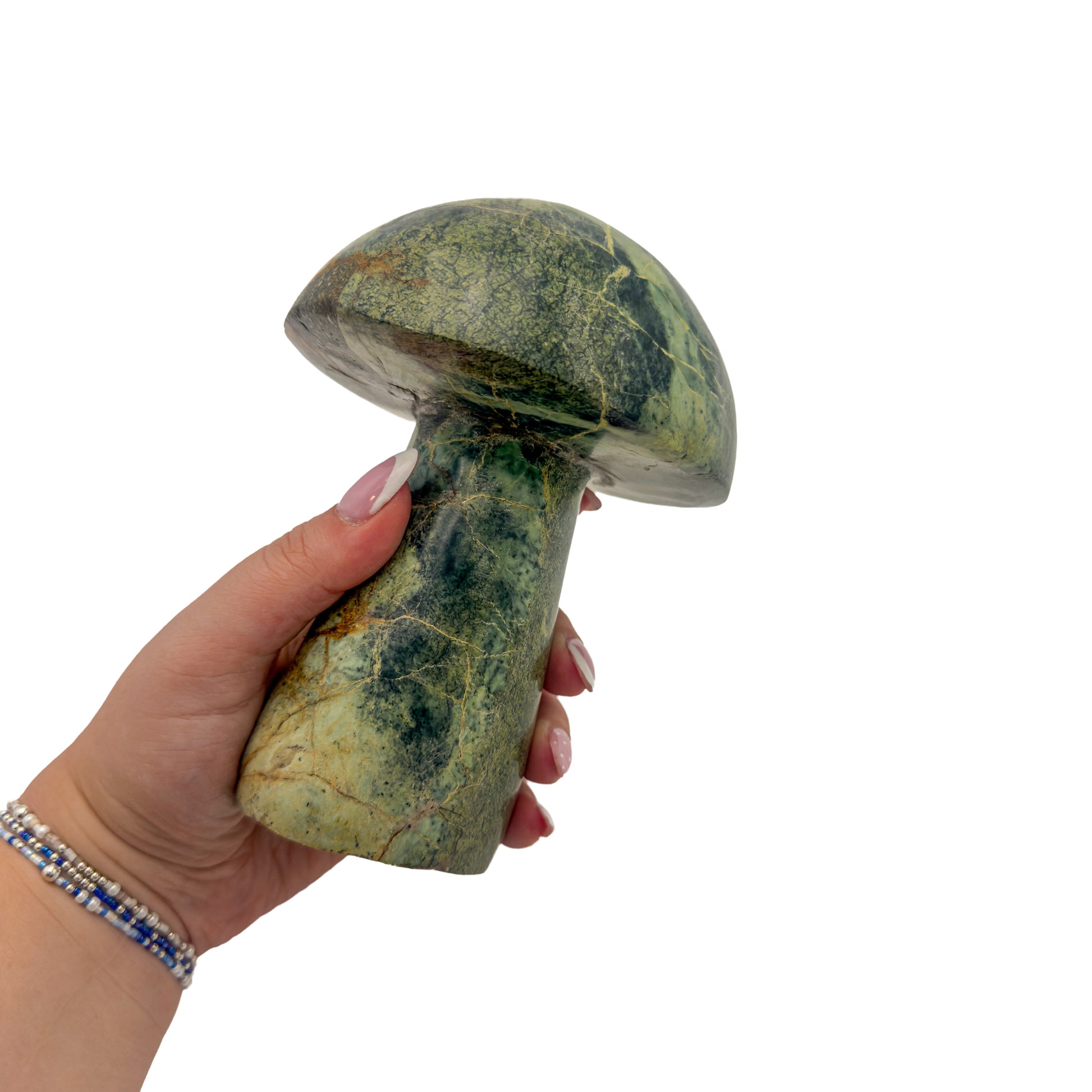 Serpentine mushroom no. 5 held in an open hand, showing the true scale of this 2.91 pound carving.