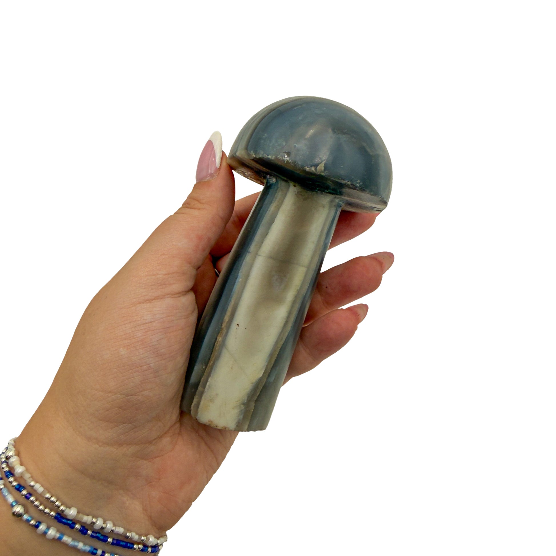Agate mushroom no. 6 held in an open hand, showing the true scale of this 4.48 inch, 0.76 pound carving.