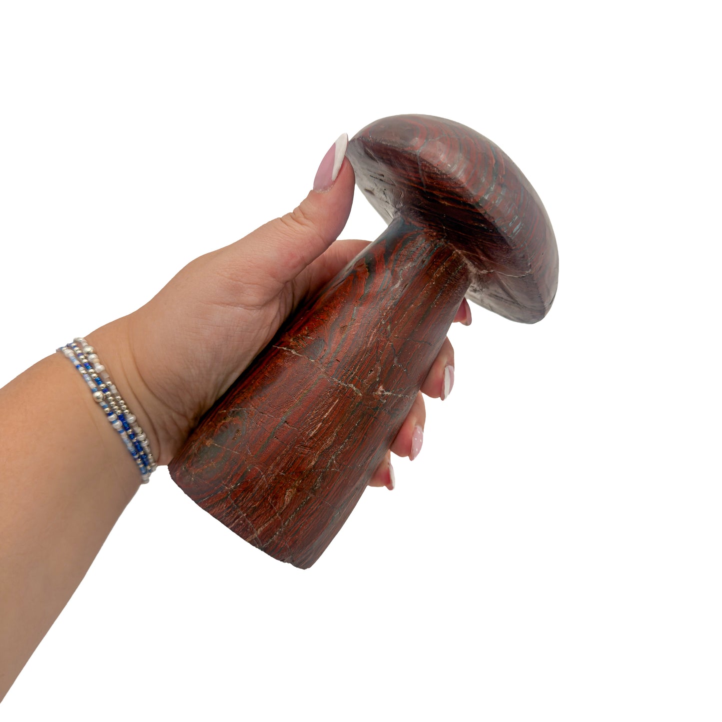 Tiger iron mushroom no. 7 held in an open hand, showing the true scale of this 6.03 inch, 2.69 pound carving.