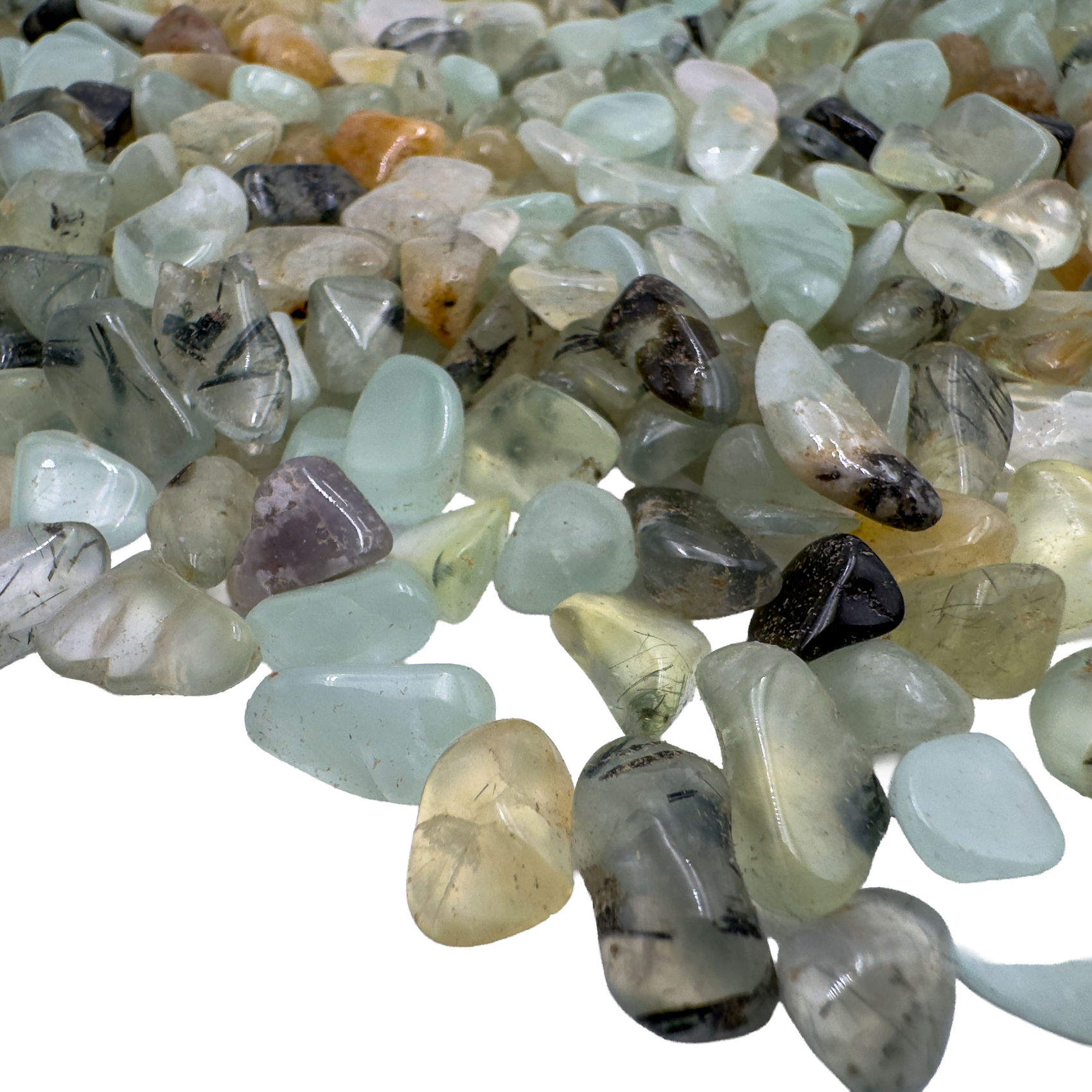 Prehnite polished chips in hand showing size reference, pale green Namibia material