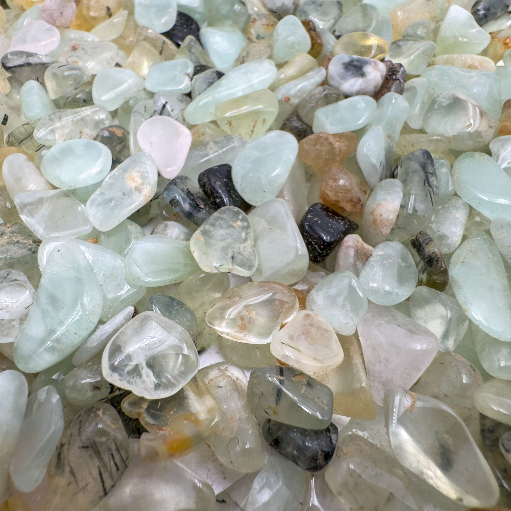 Prehnite chips scattered on surface, ethically sourced Namibia phyllosilicate