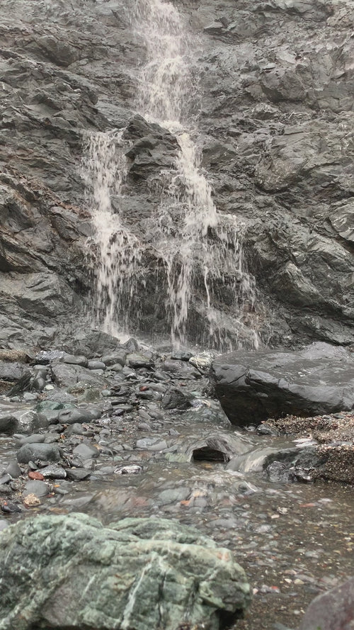 Crystal-clear water flowing through a natural mine formation, showcasing the raw beauty of crystal sourcing environments