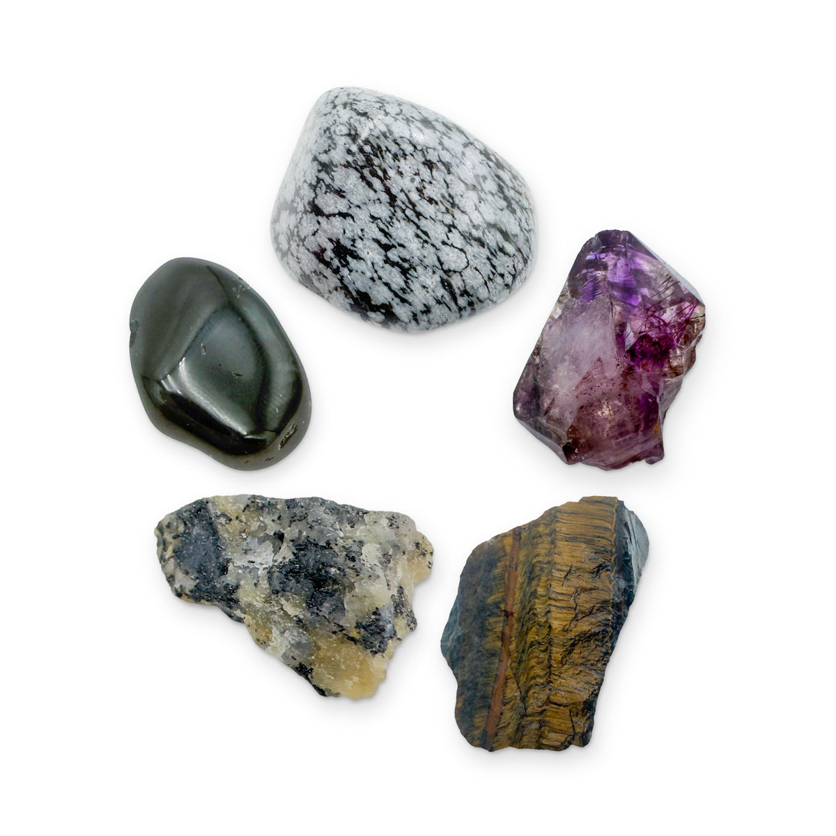The Protection Kit: black tourmaline in quartz, black tourmaline, snowflake obsidian, smoky amethyst point and tiger eye, shown together on white