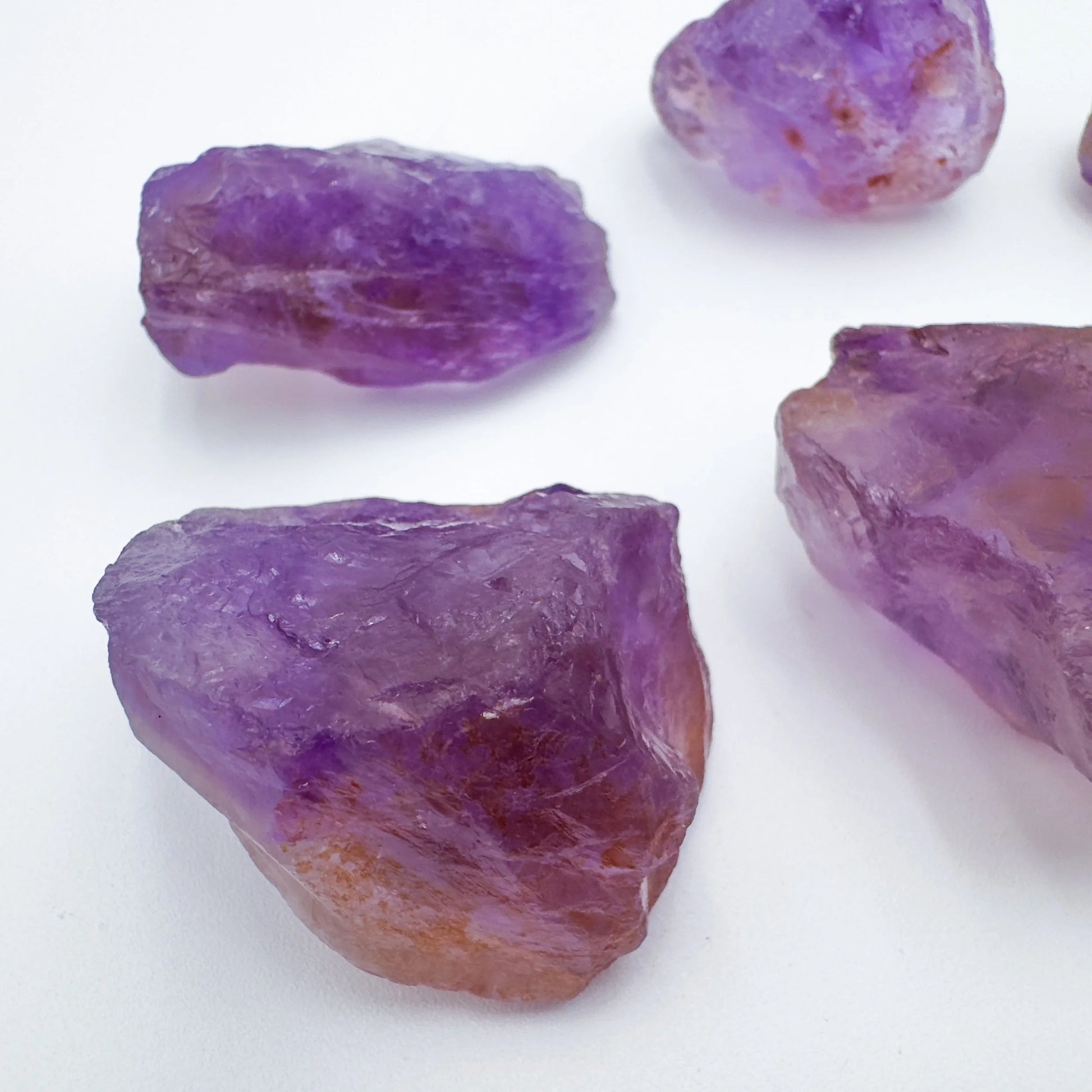 Grade aa ametrine raw held in hand for size reference