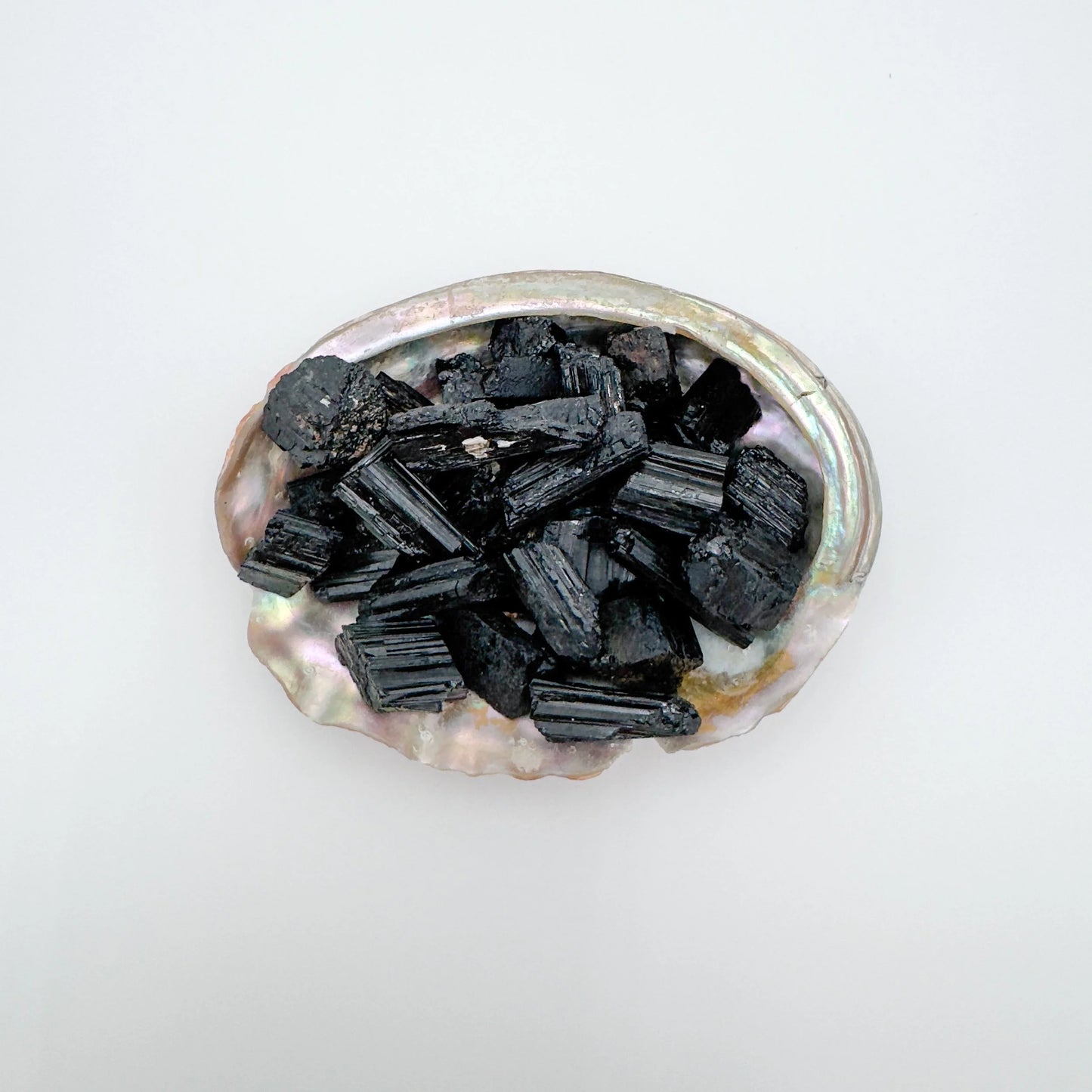 Top-down shot of Black Tourmaline raw stone, kept close for Protection, showing natural form.