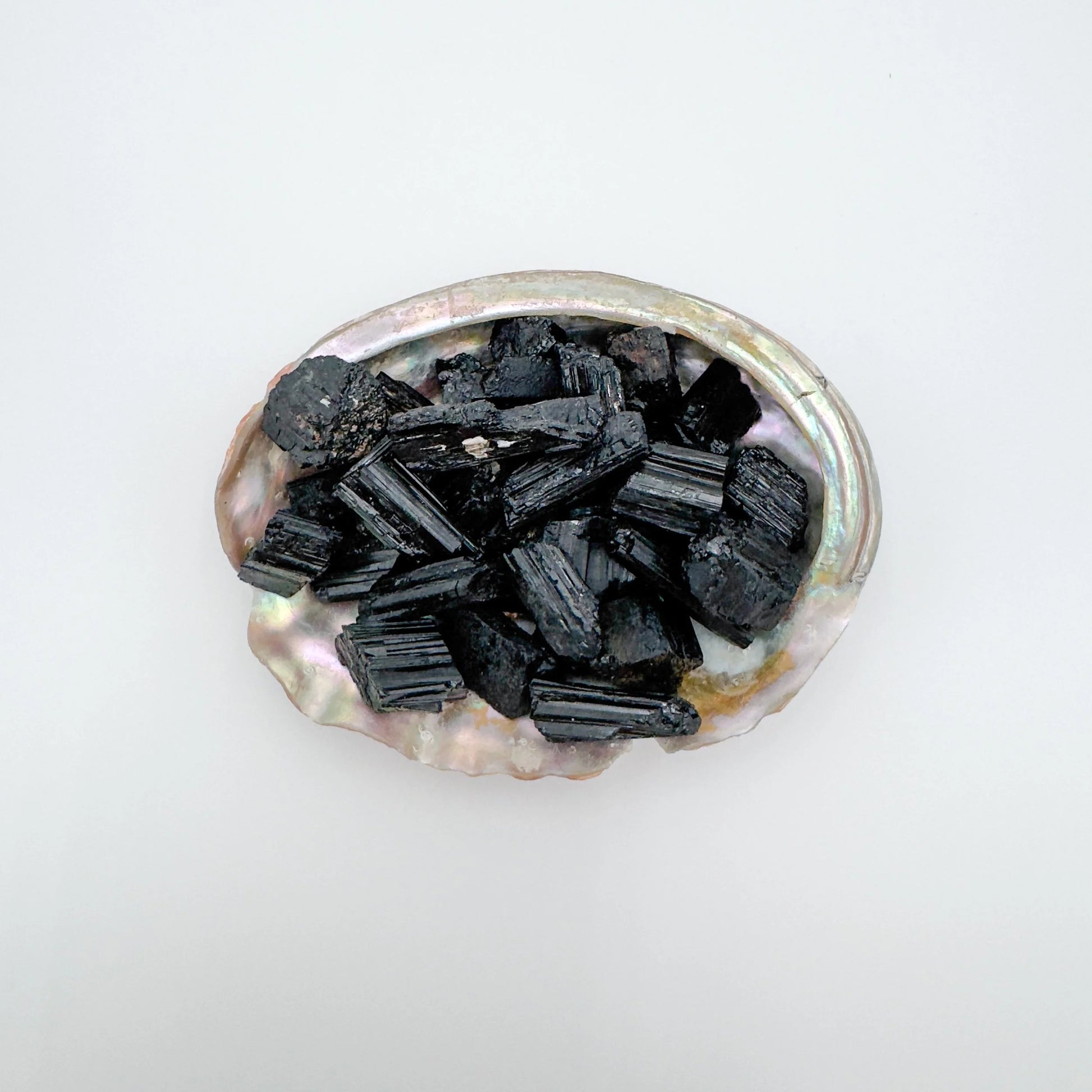 Top-down shot of Black Tourmaline raw stone, kept close for Protection, showing natural form.