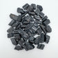 Edge-on view of Grade AA Black Tourmaline raw stone, showing characteristic finish.