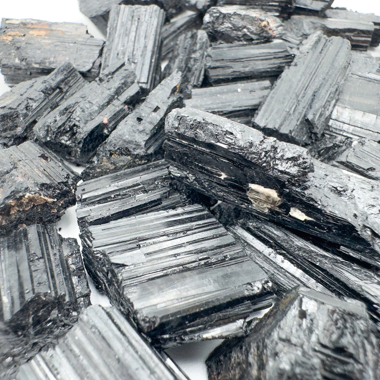 In-hand view of a Black Tourmaline raw stone, from Minas Gerais, Brazil.