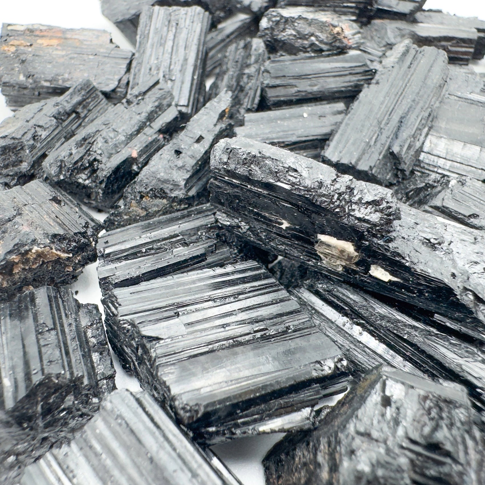 In-hand view of a Black Tourmaline raw stone, from Minas Gerais, Brazil.