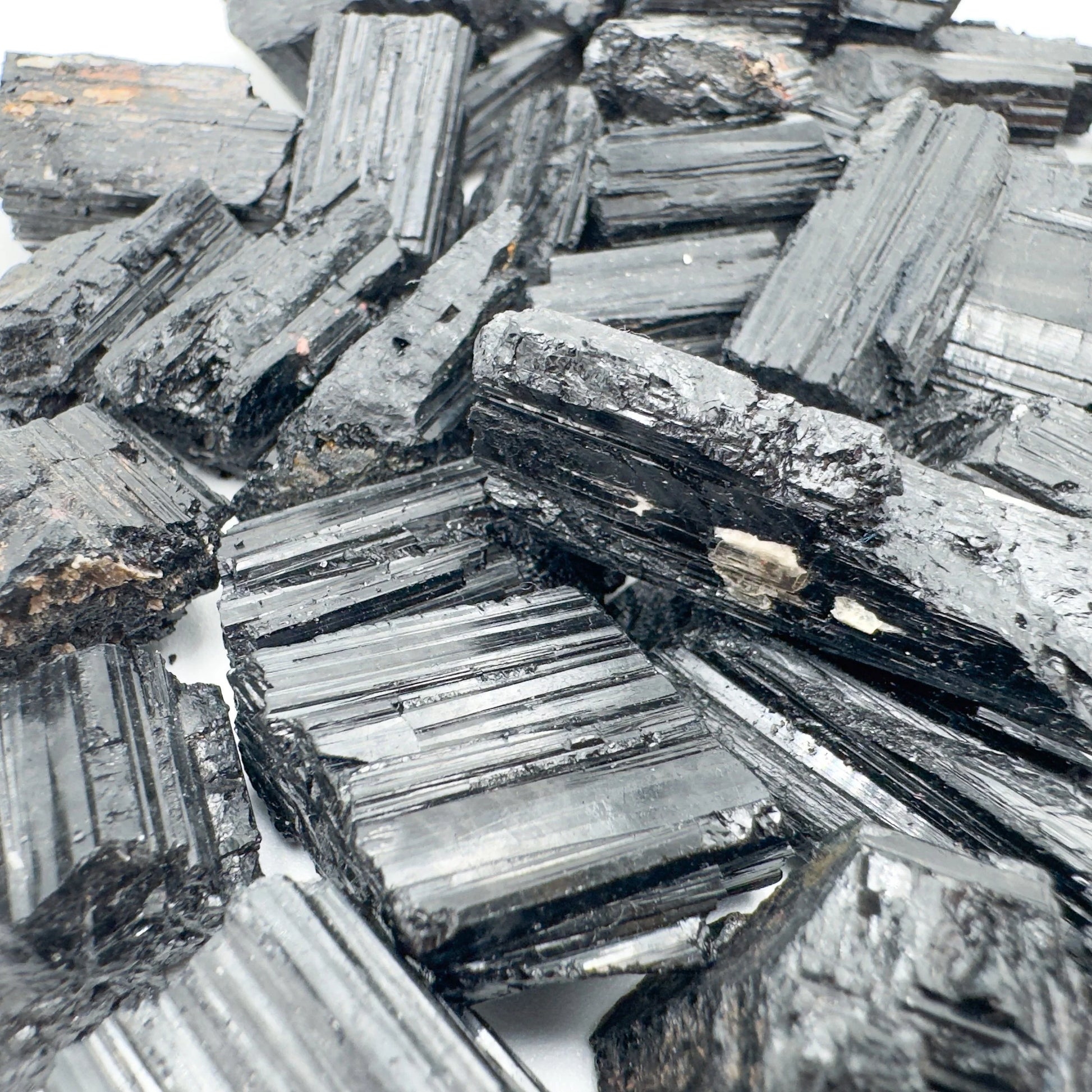 In-hand view of a Black Tourmaline raw stone, from Minas Gerais, Brazil.