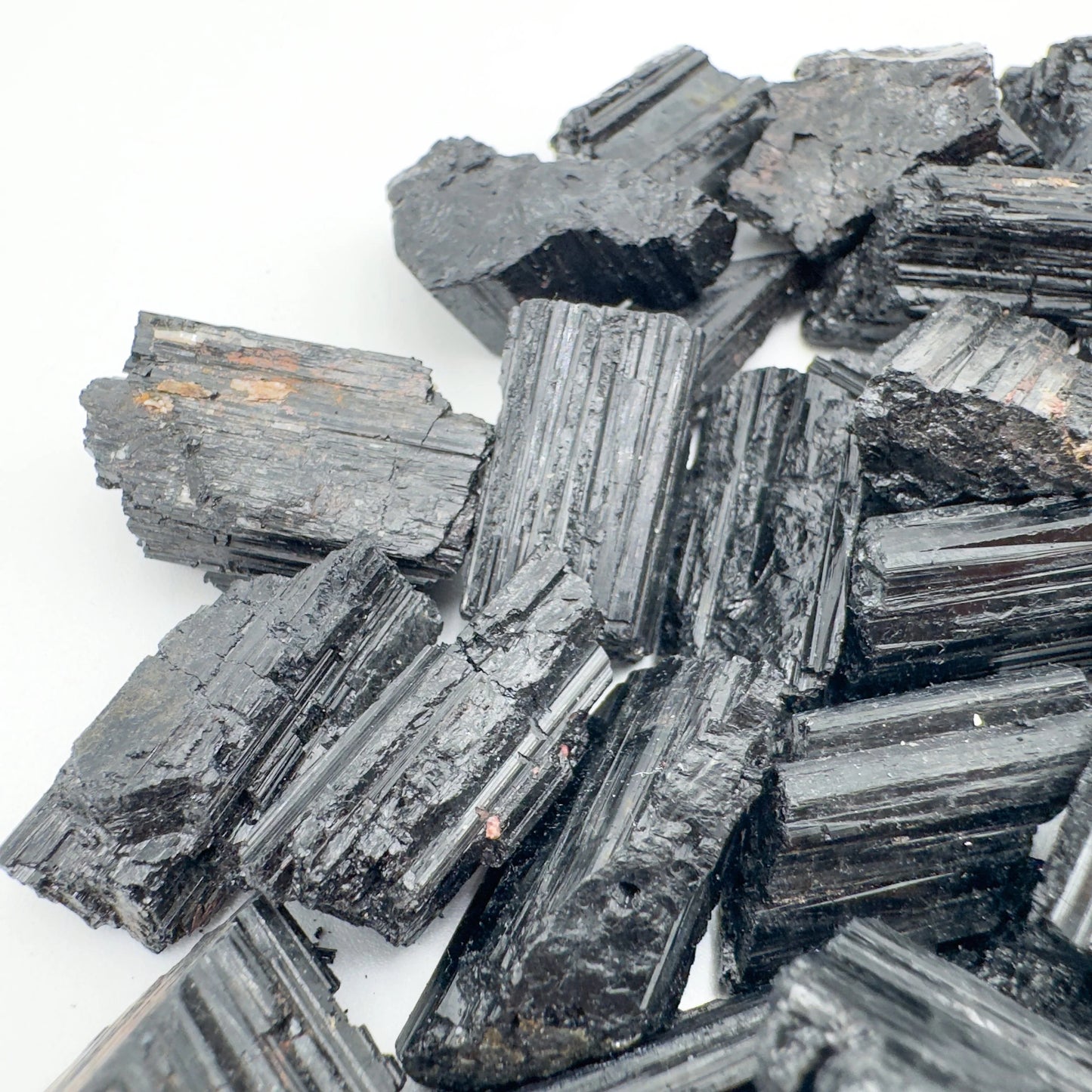 Grade aa black tourmaline raw held in hand for size reference