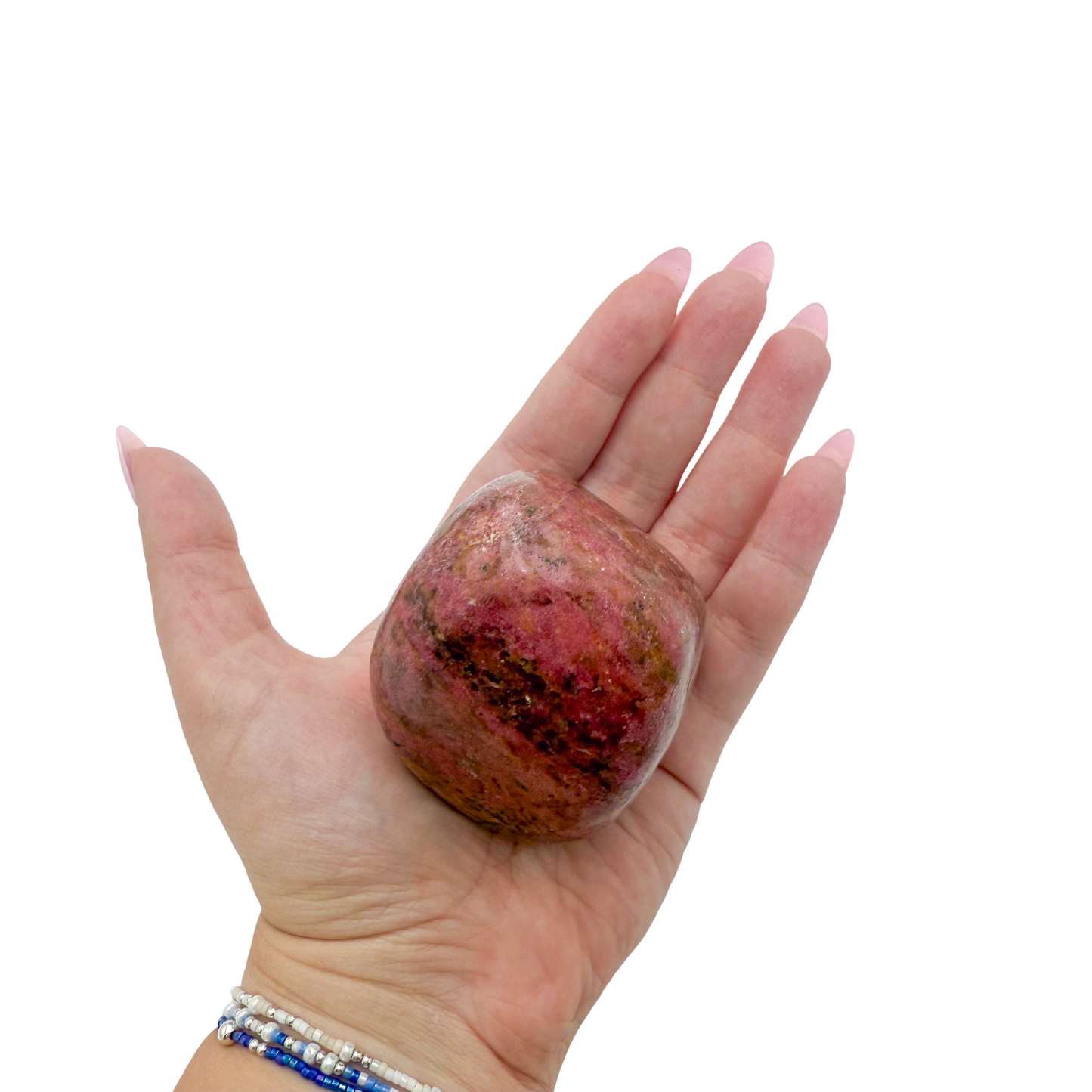 Rhodonite polished free form from Zimbabwe held in hand to show scale