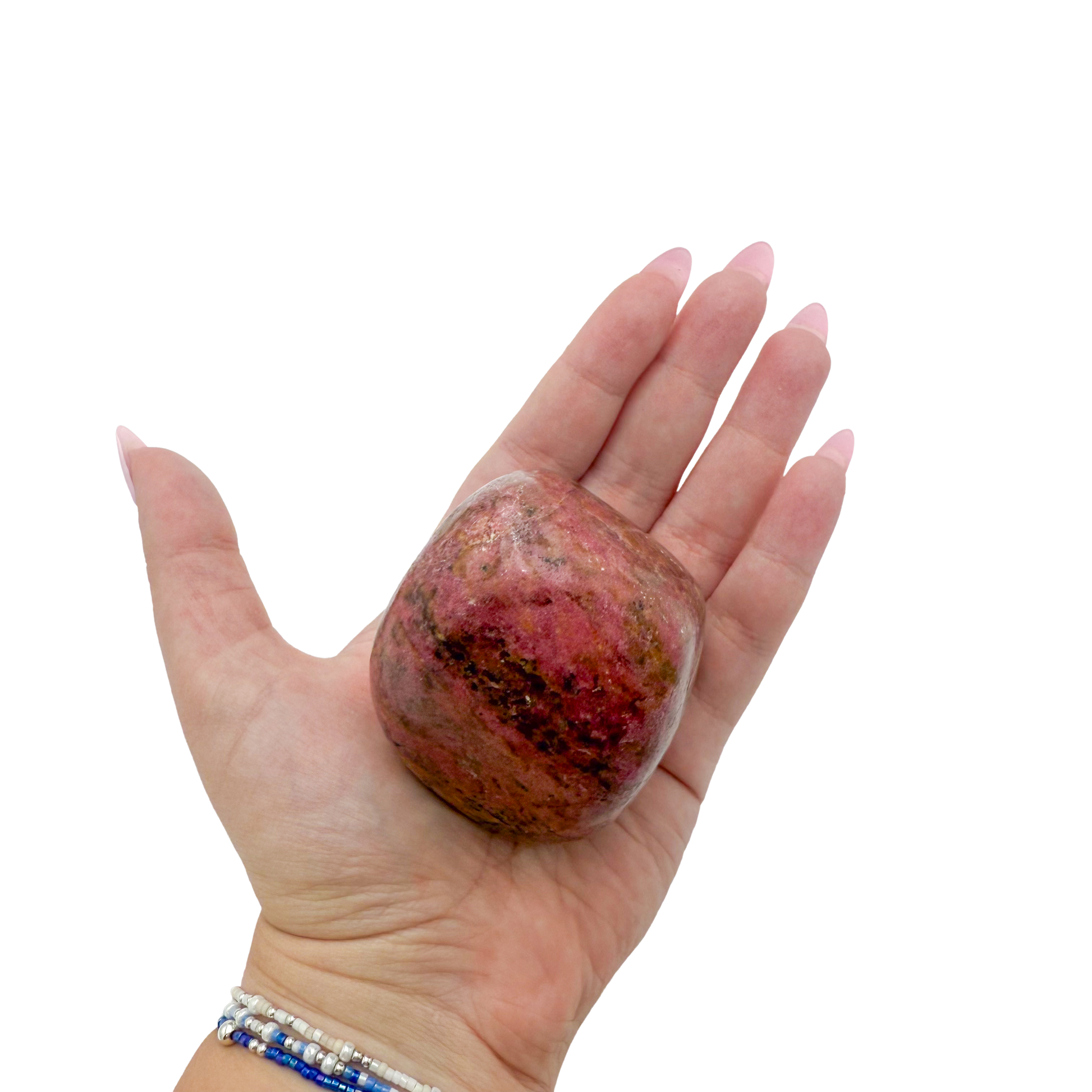 Rhodonite polished free form from Zimbabwe held in hand to show scale