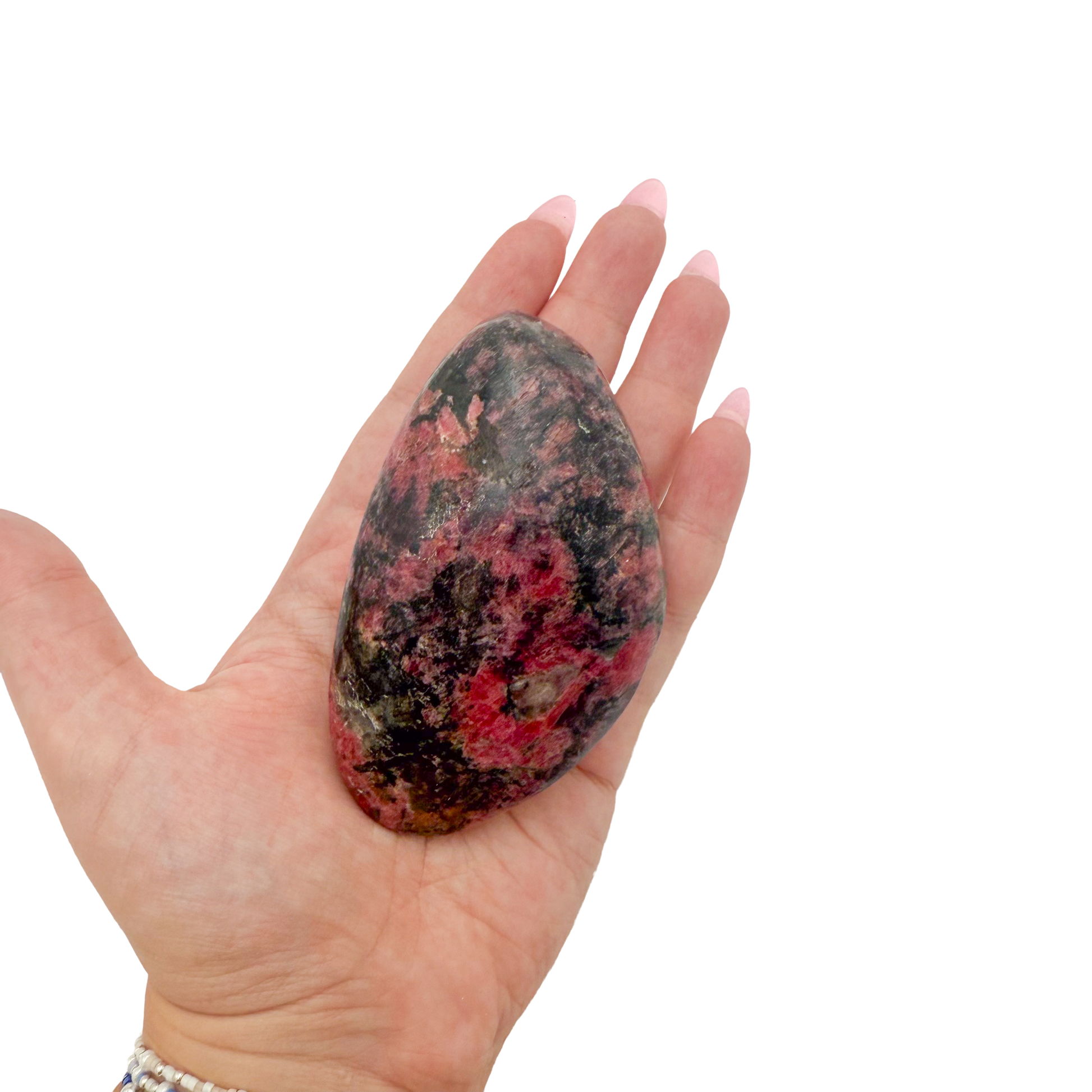 Rhodonite polished free form from Zimbabwe held in hand to show scale