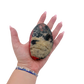 Rhodonite polished free form from Zimbabwe held in hand to show scale